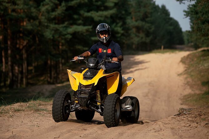 Private Snowmobile or ATV Safari with Riga Black Balsam Tasting - Riding the quad bike among the trees