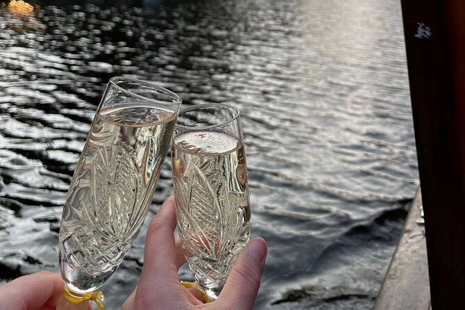 Riga: Evening or Sunset Boat Tour with Drink and Audio Guide - The welcome drink and onboard atmosphere